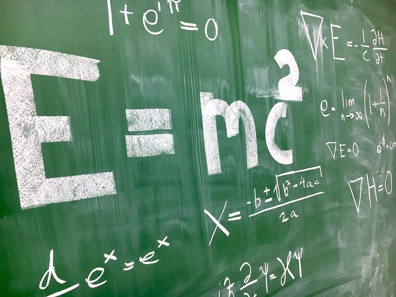 Teacher using a chalkboard for science instruction