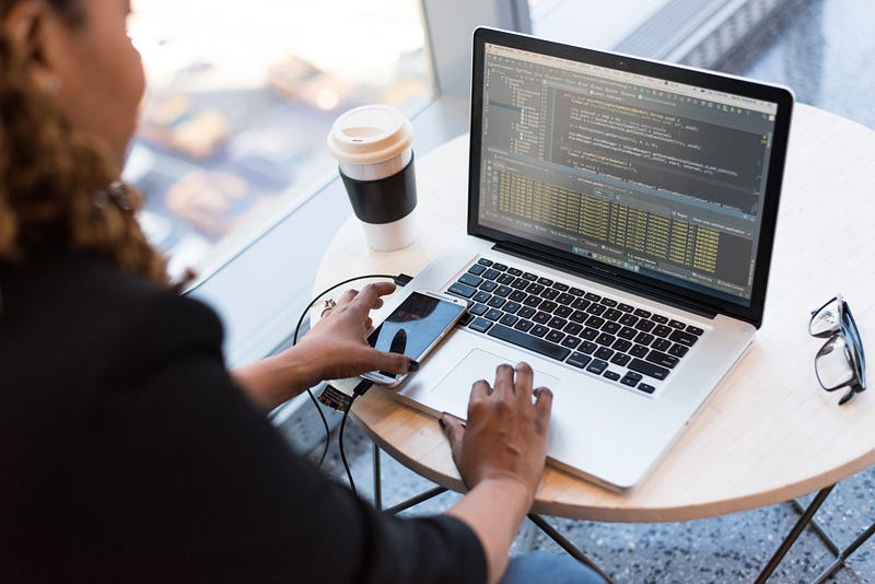 Woman coding on a laptop